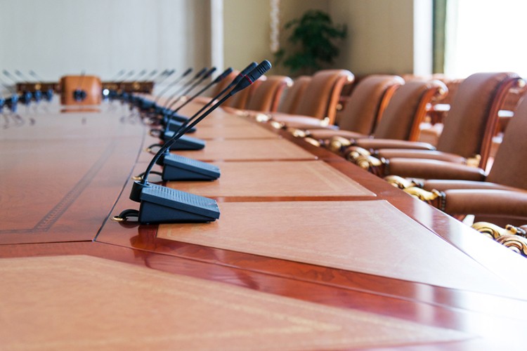 Empty corporate boardroom table set up with microphones - Snappy Photobooths
