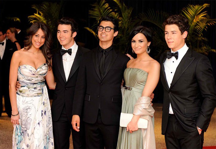Group photo of five people in formal eveningwear at a red carpet event - Snappy Photobooths blog