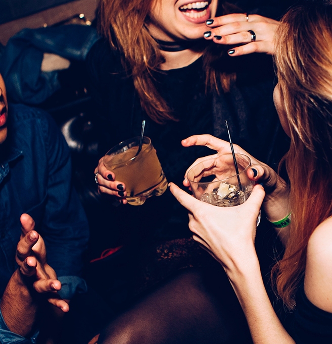 Guests laughing and enjoying cocktails together at a party - Snappy Photobooths