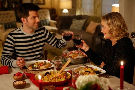 Couple sharing a candlelit dinner and toasting red wine - Snappy Photobooths anniversary celebration