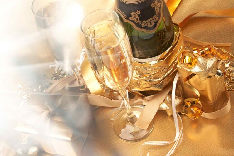 Champagne bottle and glasses with gold decorations at an anniversary celebration - Snappy Photobooths