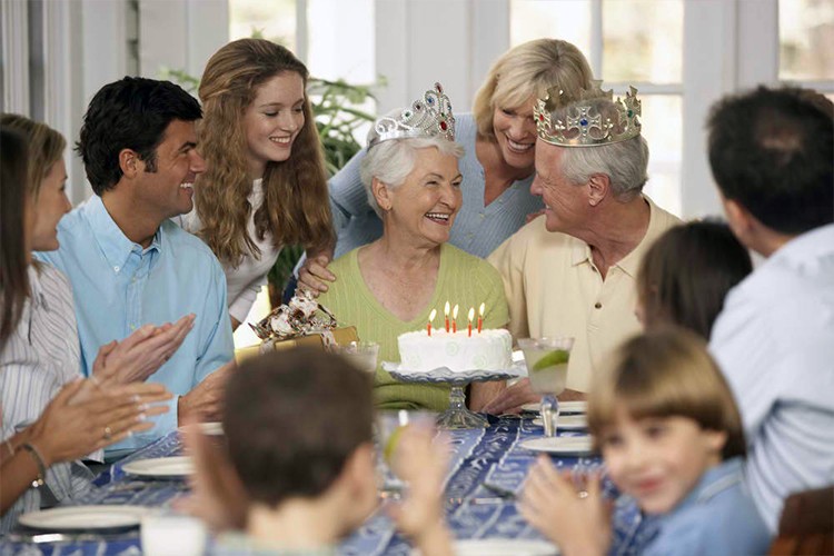 Multi-generational family celebrating an anniversary with the couple wearing crowns - Snappy Photobooths